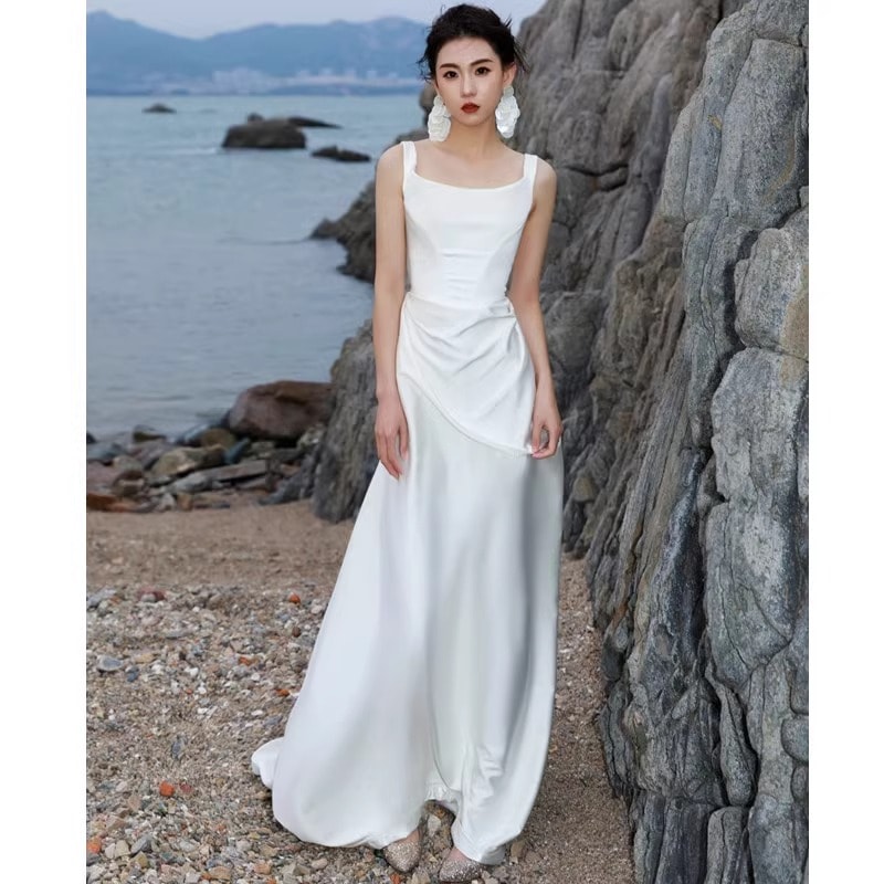 旅は軽ウェディングドレスを撮る超仙簡約白色スリム韓国式2023新型海辺ロケ迎賓紗冬