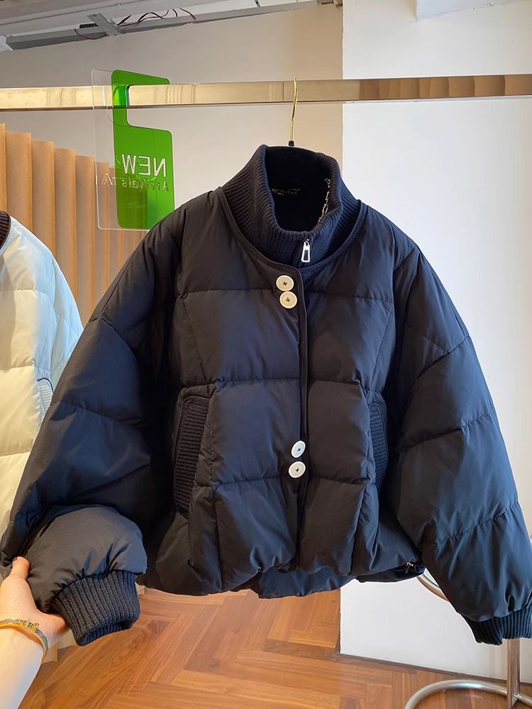 デザイン感小衆ゆるいニット立襟ダウンジャケット女性冬の新型衝突色白鴨パイルコート