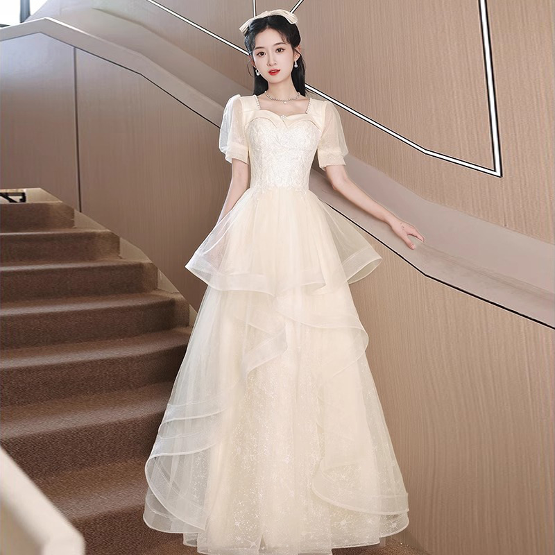 シャンパン色のタキシードのスカートの女性のハイエンドの軽い豪華な大衆の高級感の卒業する成人式の司会者の芸考の演出服