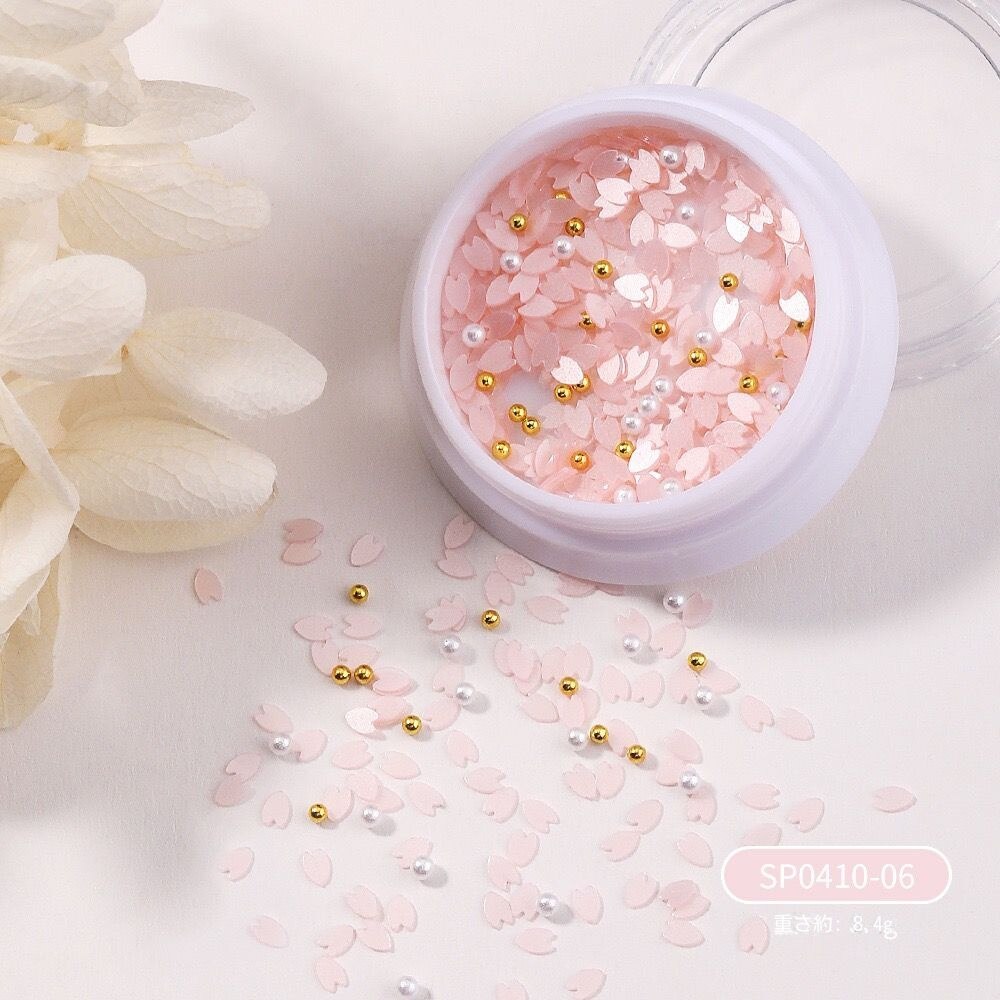 【10点セット】23ネイルアート桜のスパンコールアクセサリー白い花びらのフラッシュビーズを混ぜて甲飾りを着ている