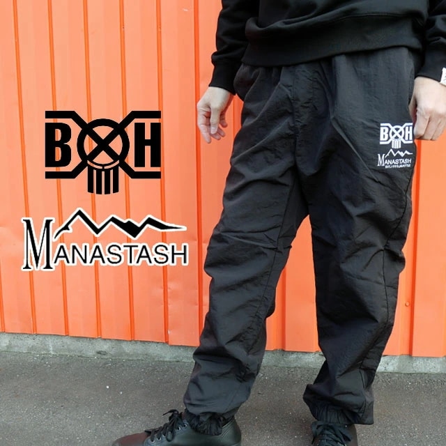 マナスタッシュ バウンティーハンター メンズ ボトムス トラックパンツ コラボモデル 長ズボン 防寒 キャンプ アウトドア アパレル カジュアル ウェア 792-5210012 010 ブラック 黒