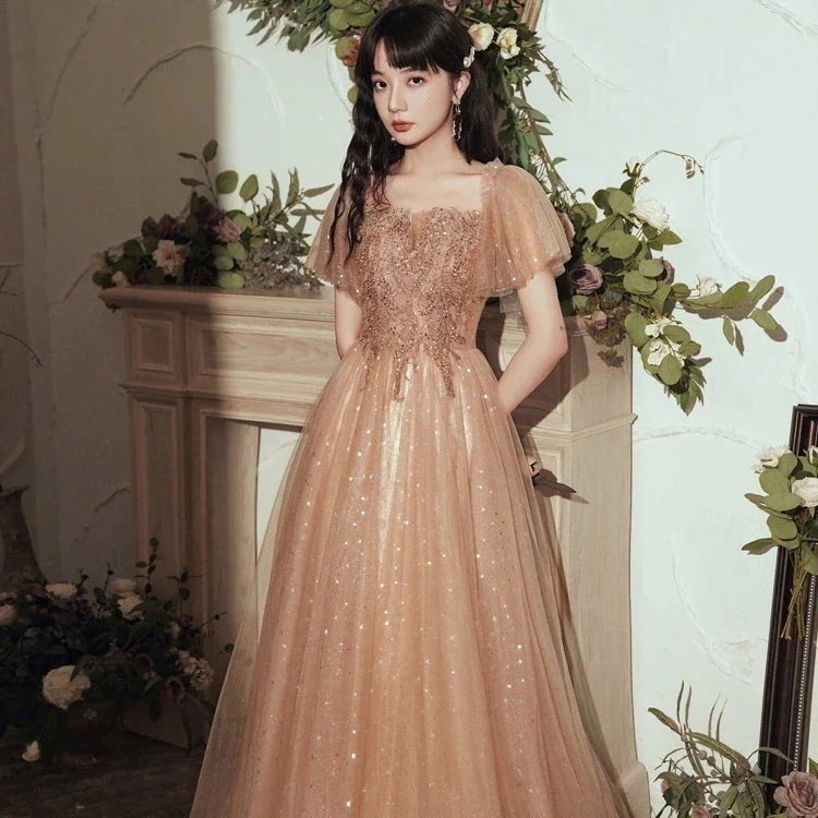 女性のためのワンショルダーイブニングドレス2024新しい気質宴会ピンク妖精ロングエレガントなホストドレス