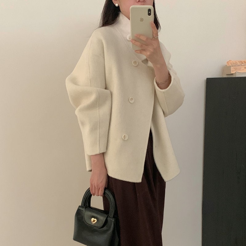 ロングウールのウサギのベルベットの高級両面カシミヤのコート女性2023秋の新型両面のコートはゆるい短い毛ですね